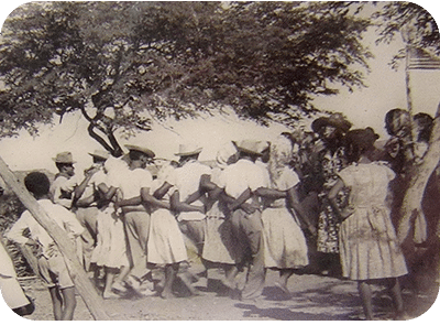 The Simadan (Harvest) Dance, notice the base's U.S. Flag in the upper right corner.